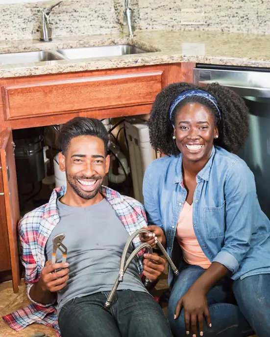 Couple working under sink